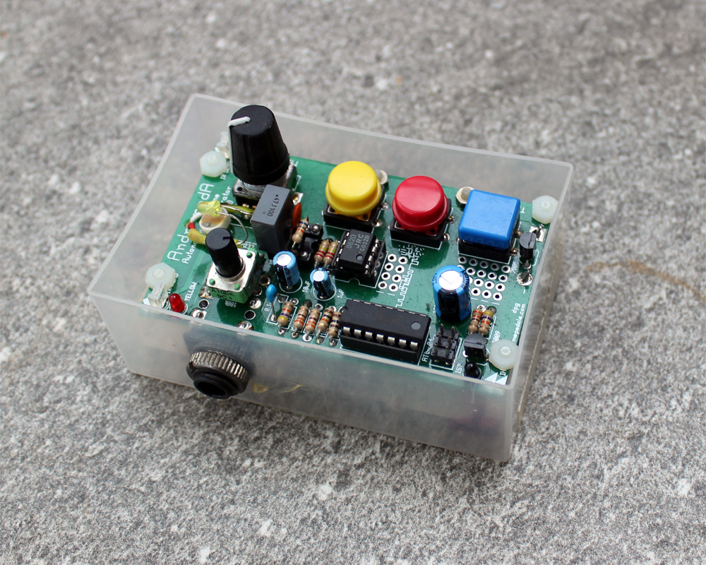 A hand made electronic instrument: circuitboard and components in a plastic shell