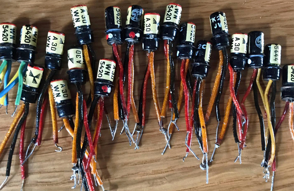 A cluster of vintage transistors that are used to make a fuzz pedal