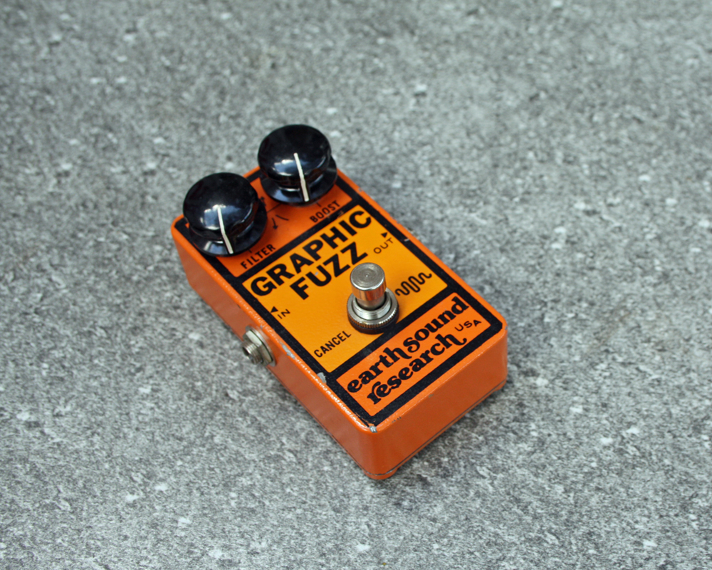 Vintage guitar fuzz pedal with bold orange 1970s graphics and large knobs