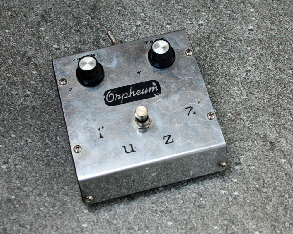Vintage guitar fuzz pedal, metal, chrome finish, wedge-shaped, two knobs, foot switch on top and screen-printed brand name