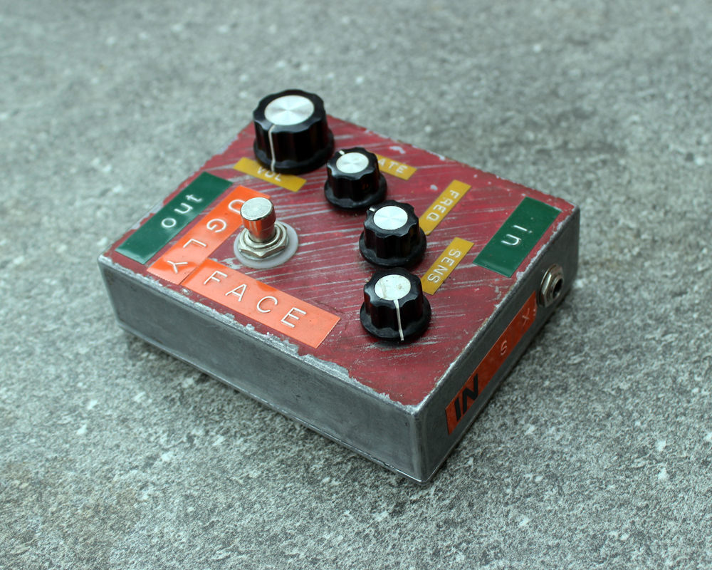 A hand made electronic pedal: metal, plastic knobs, dymotape