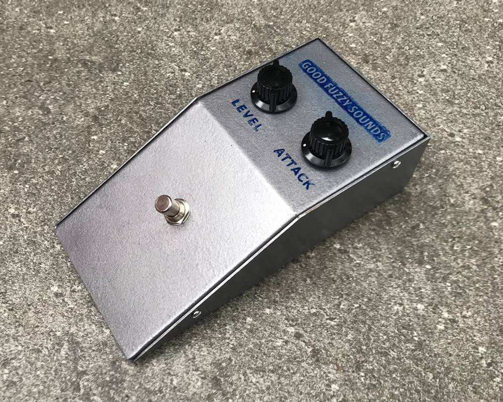 Good Fuzzy Sounds Bad Motorscooter fuzz pedal, wedge-shaped metal enclosure with two knobs, a foot switch, extremely basic righteous-looking